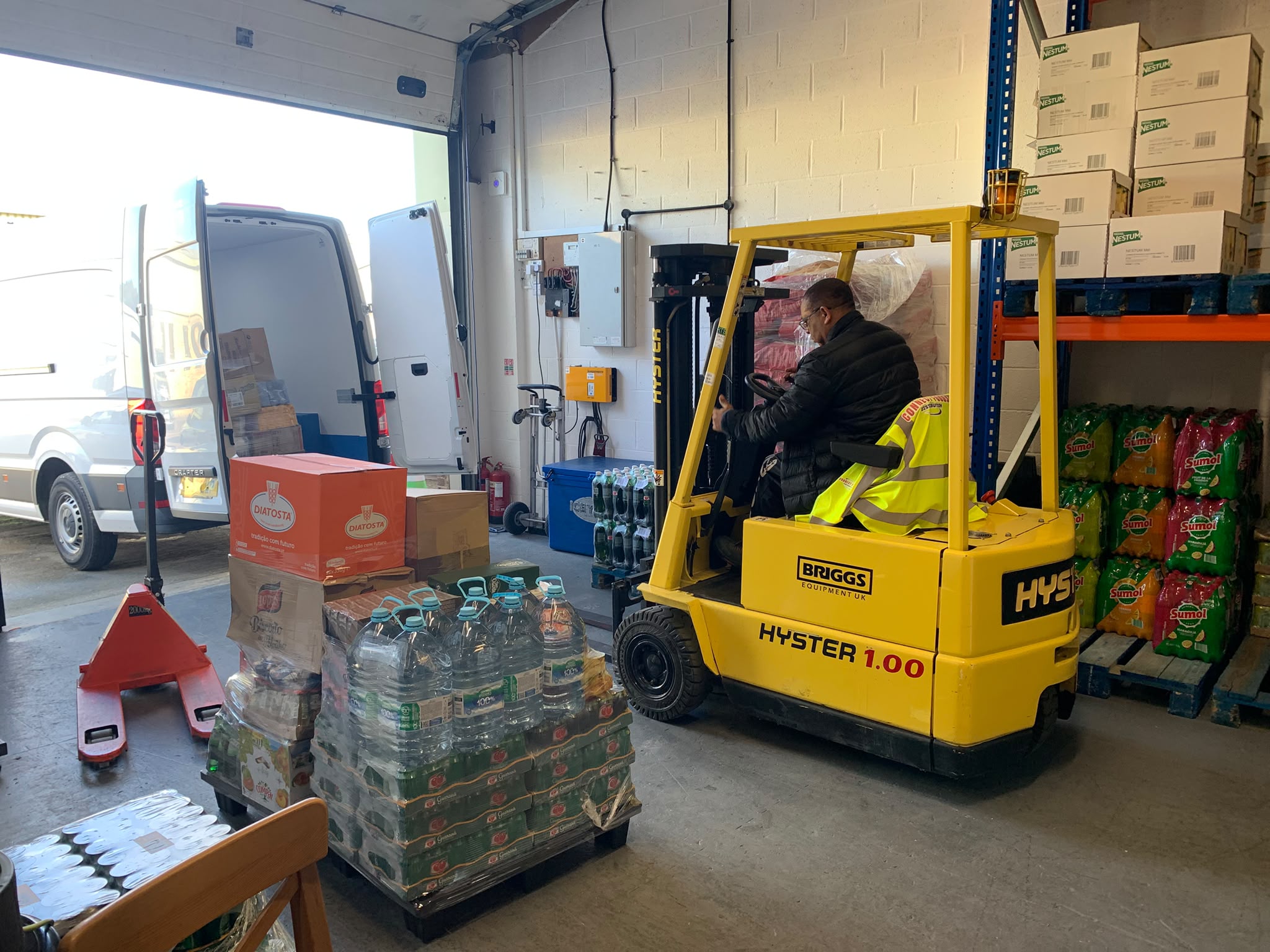 Team member loading customer orders with a forklift in the Connect Foods warehouse
